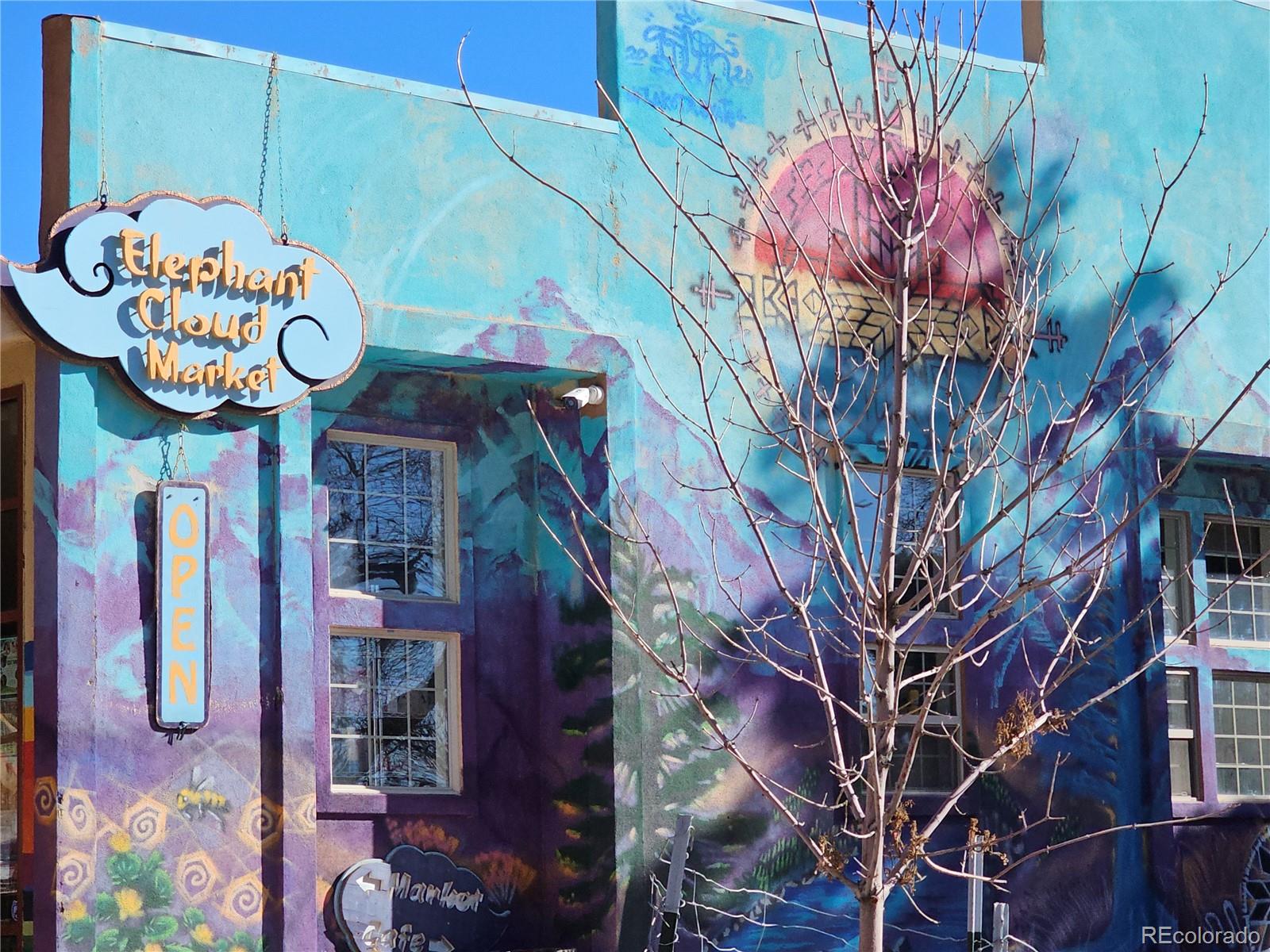 170 Wagon Wheel Road Crestone, CO 81131 - Photo 15 of 20 a front view of a multi story building with a tree