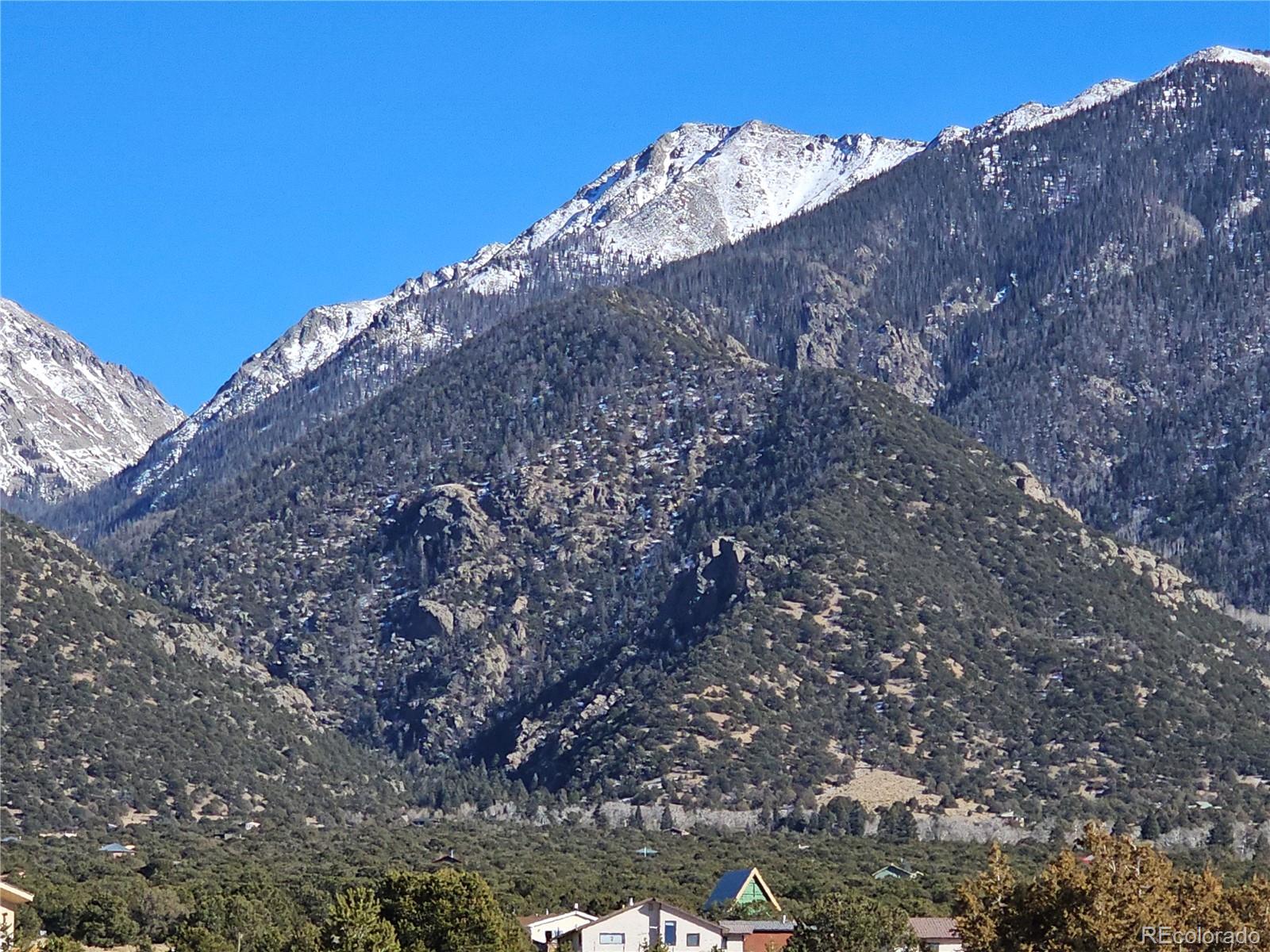 170 Wagon Wheel Road Crestone, CO 81131 - Photo 6 of 20 a view of a dry yard with mountains in the background