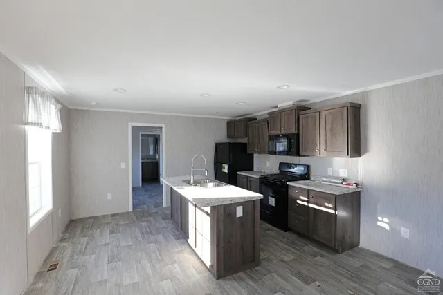 a kitchen with stove a sink and refrigerator