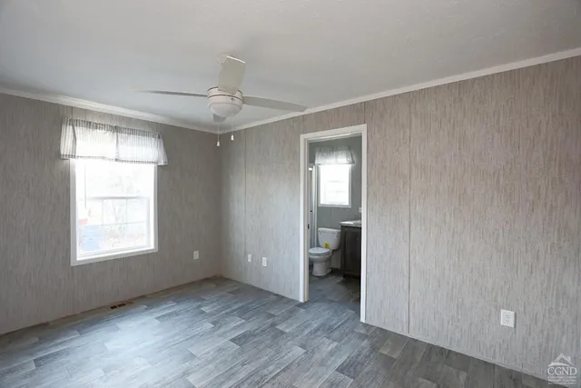 a view of a room with wooden floor closet and windows