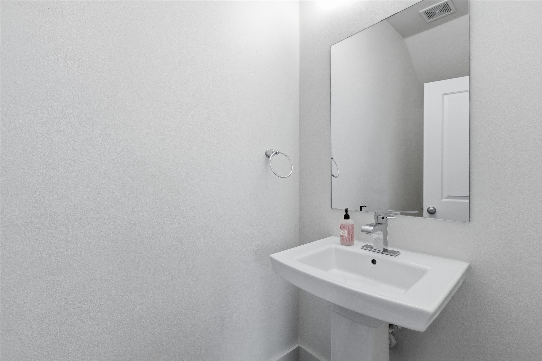 4124 Valley View Road, Unit 4A & 4B Austin, TX 78704 - Photo 11 of 40 A well-appointed half bath features a sleek pedestal sink and a framed mirror.