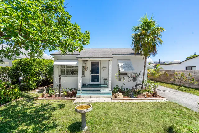 a view of a house with backyard porch and sitting area