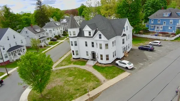 an aerial view of residential houses with yard