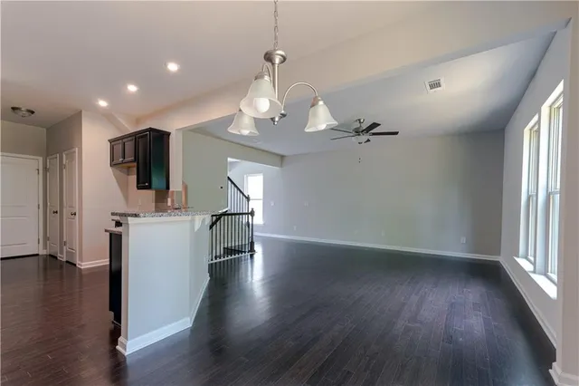 wooden floor fireplace and windows in an empty room