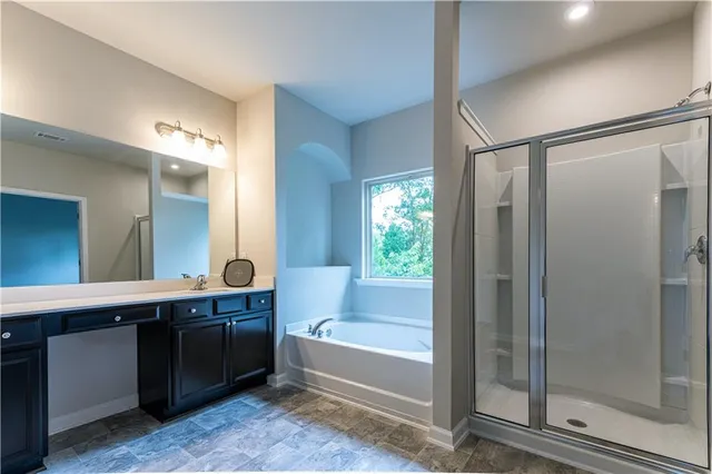 a bathroom with a tub shower and sink