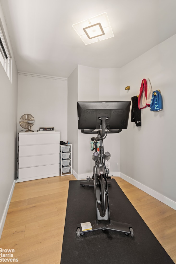 383 Grand Street, Unit M2002 Manhattan, NY 10002 - Photo 10 of 12 a room with gym equipment