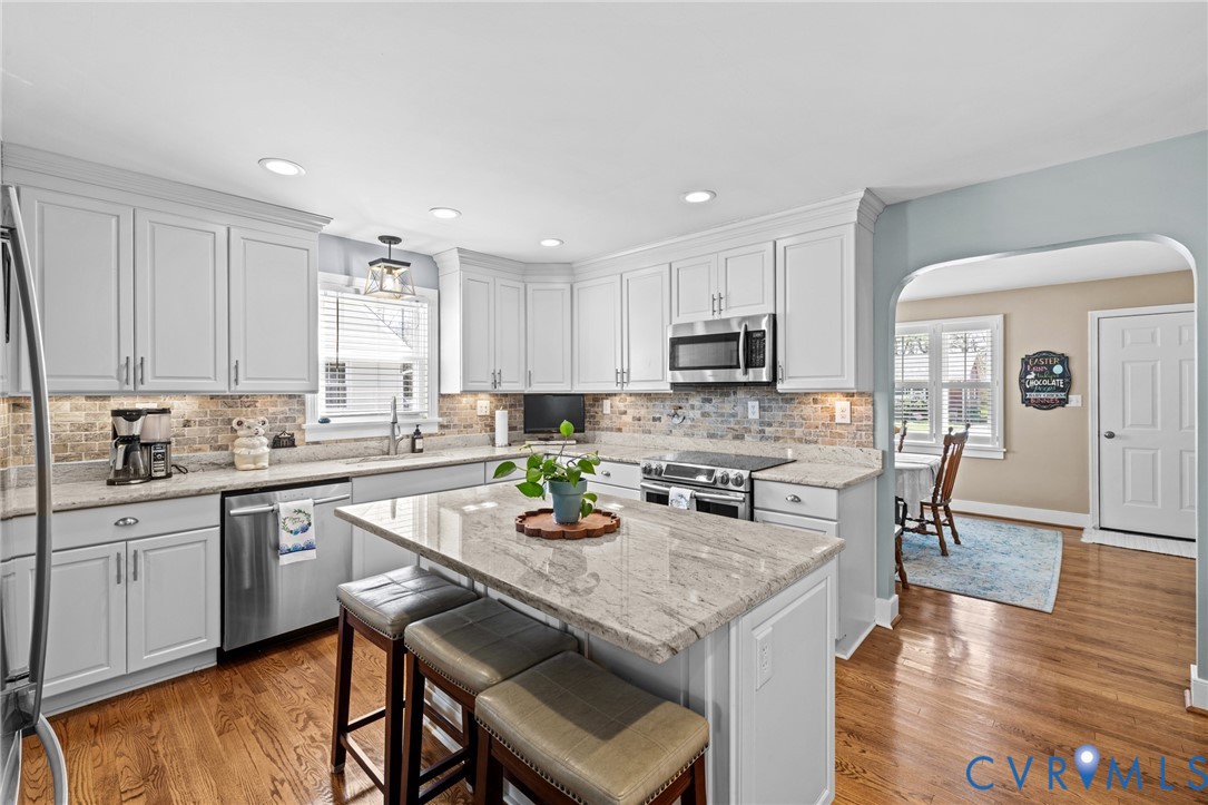 408 John Street Ashland, VA 23005 - Photo 1 of 45 a kitchen with a stove a sink a dining table and chairs