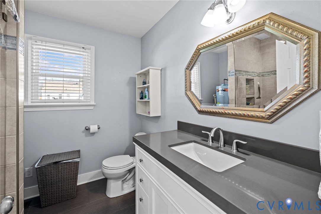 408 John Street Ashland, VA 23005 - Photo 25 of 45 a bathroom with a toilet a sink and mirror