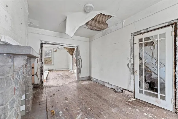 a view of a livingroom with a walk in closet and bedroom
