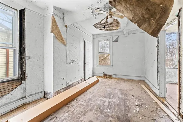 a view of a hallway with a sink and painted walls
