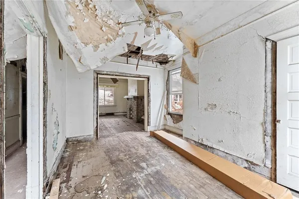 a view of a hallway with a dining table chairs and entryway