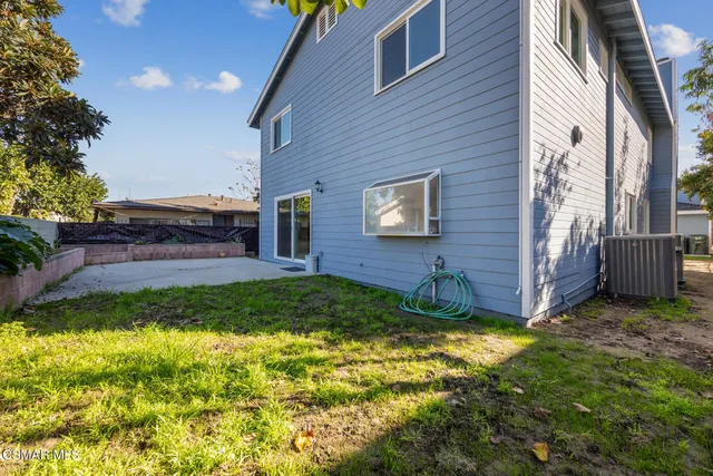 an aerial view of a city with lots of residential buildings and mountain view in back