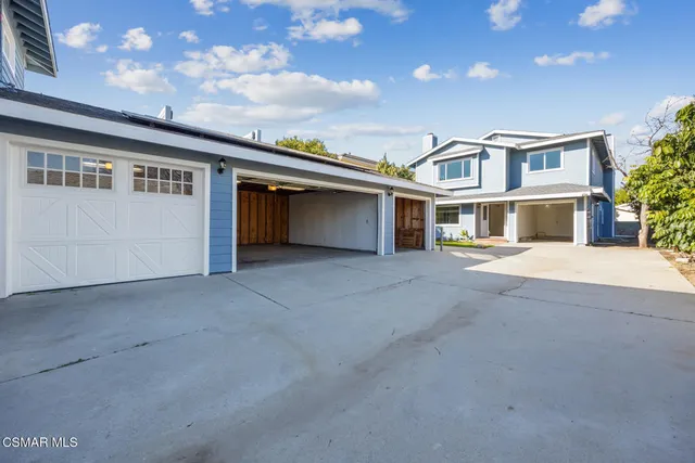 an aerial view of residential houses with city view