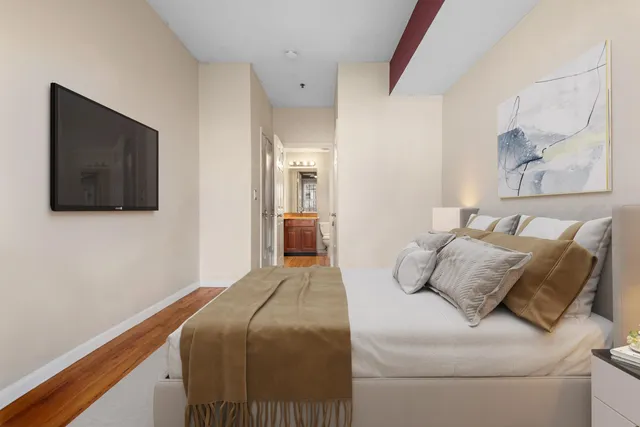 a bedroom with a bed and a flat screen tv