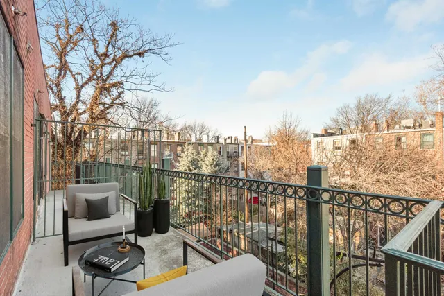 a view of a balcony with furniture