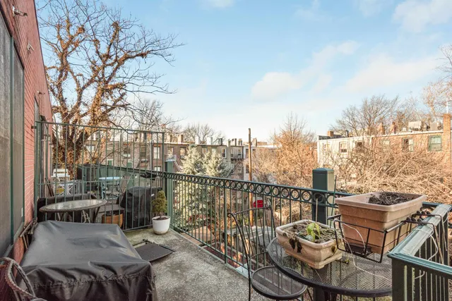 a view of a balcony with two chairs and a table