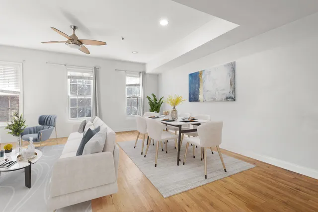 a living room with furniture and a wooden floor