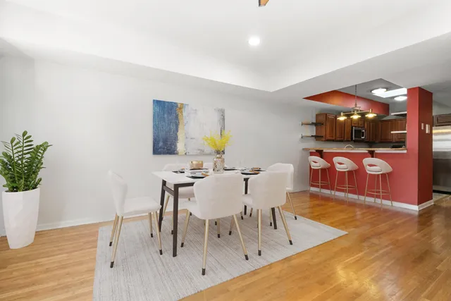 a view of a dining room with furniture and wooden floor