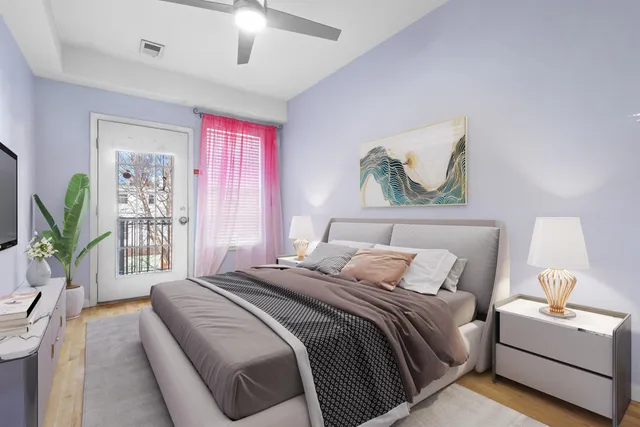 a bedroom with a balcony a bed and a painting on the wall