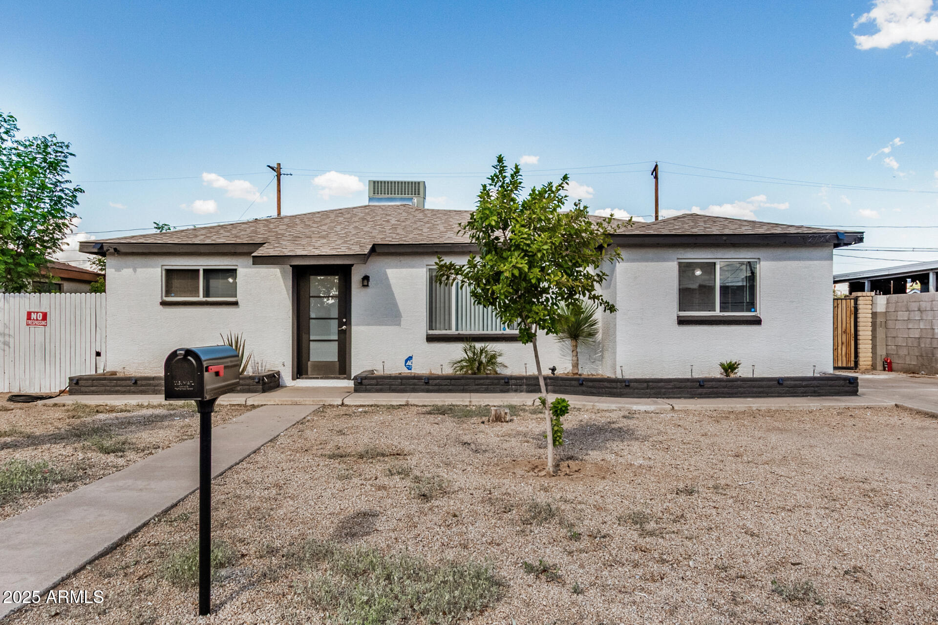2726 West Ruth Avenue Phoenix, AZ 85051 - Photo 1 of 28 a front view of a house with garden
