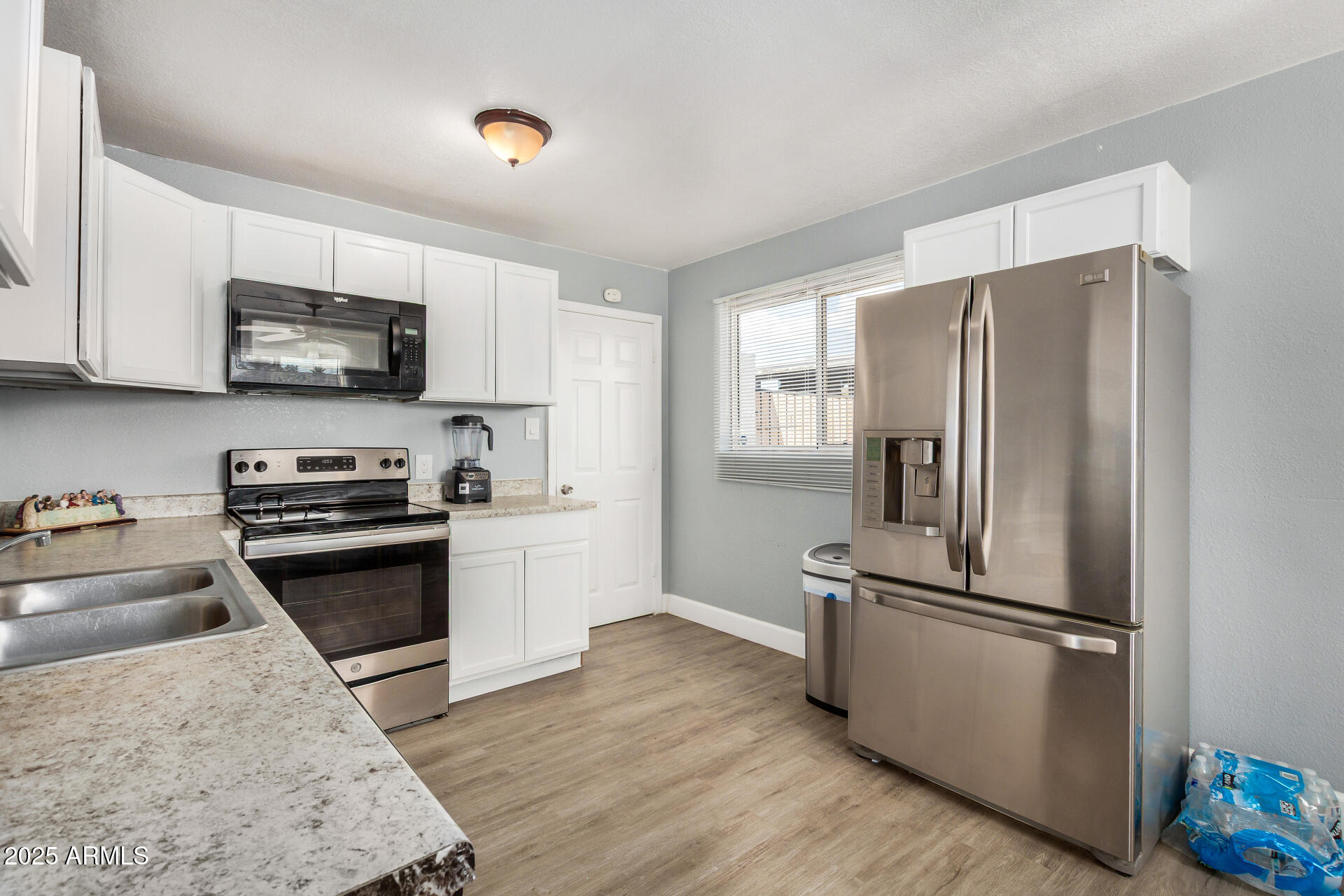 2726 West Ruth Avenue Phoenix, AZ 85051 - Photo 14 of 28 a kitchen with stainless steel appliances granite countertop a refrigerator stove and sink