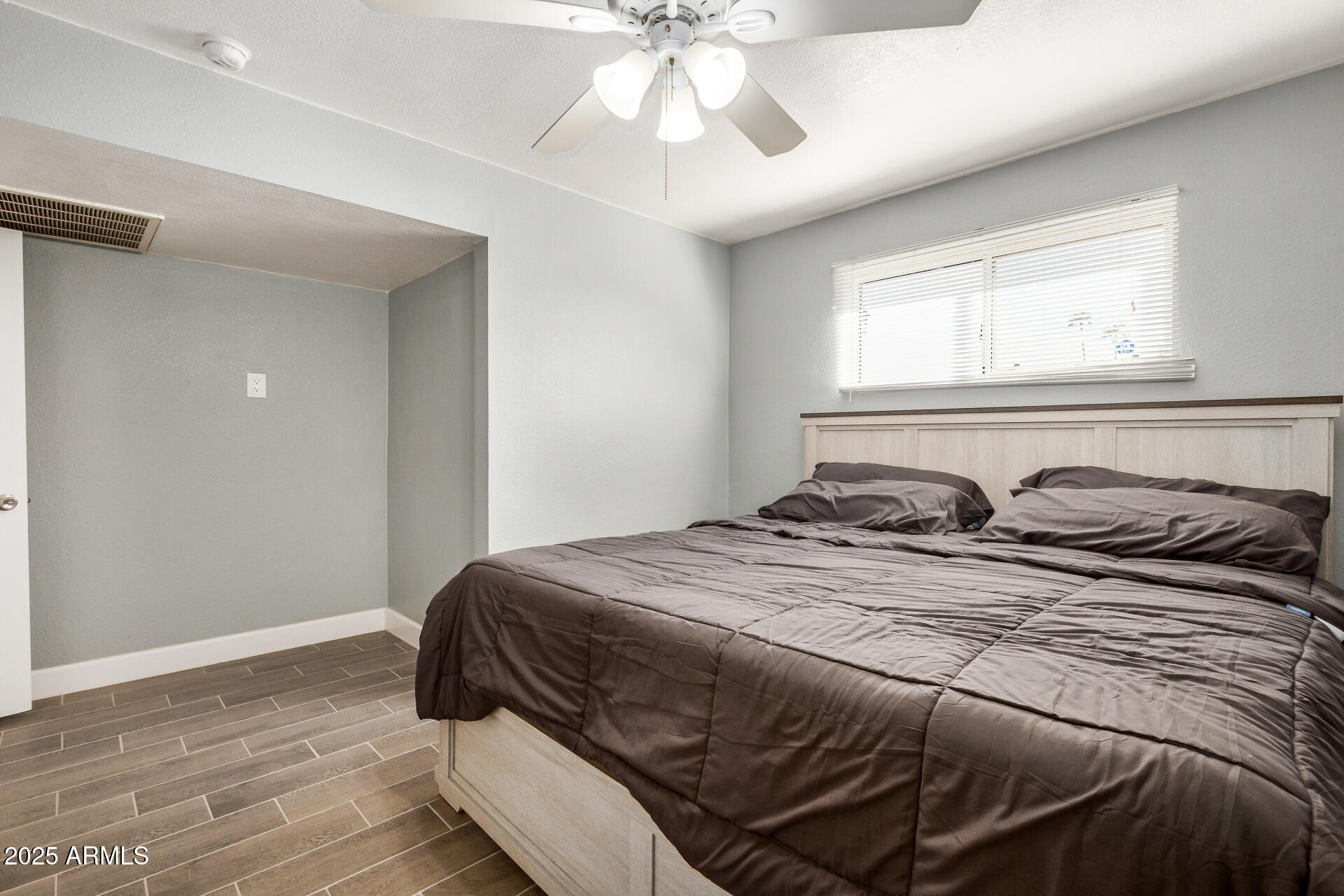 2726 West Ruth Avenue Phoenix, AZ 85051 - Photo 15 of 28 a bedroom with a bed and window