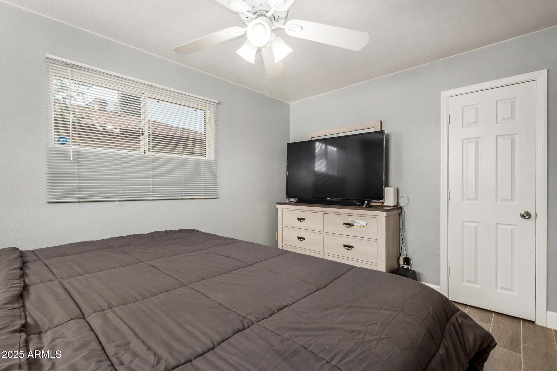 2726 West Ruth Avenue Phoenix, AZ 85051 - Photo 17 of 28 a bedroom with a bed and a flat screen tv