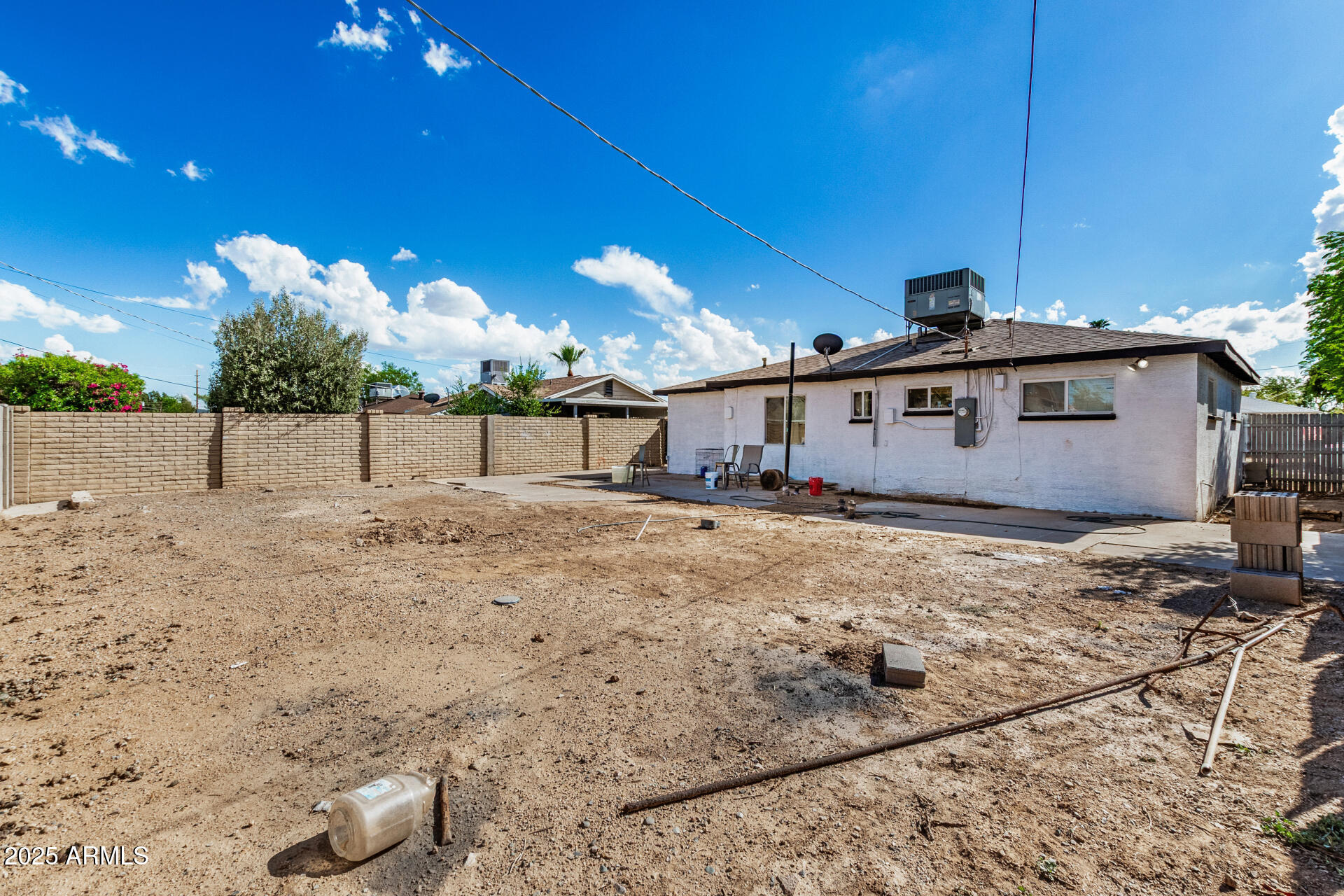 2726 West Ruth Avenue Phoenix, AZ 85051 - Photo 27 of 28 a view of a dry yard with wooden fence