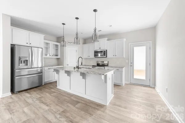 a view of livingroom with hardwood floor and kitchen view