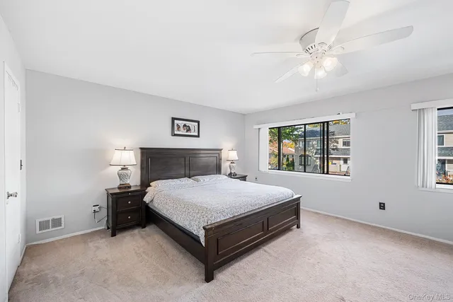 a spacious bedroom with a bed and window