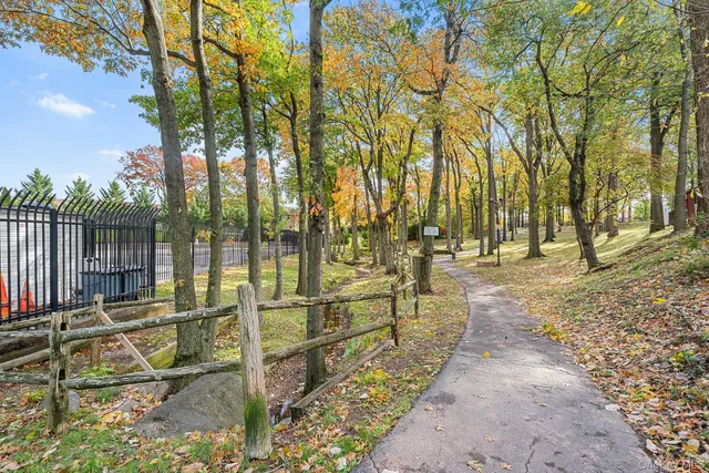 a view of a yard with wooden fence