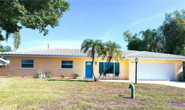 a front view of house with yard and trees