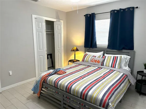 a bedroom with a bed and window