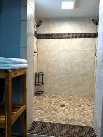 a bathroom with a granite countertop toilet a sink and a mirror