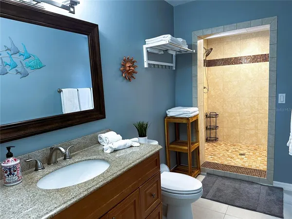 a utility room with granite countertop cabinets washer and dryer