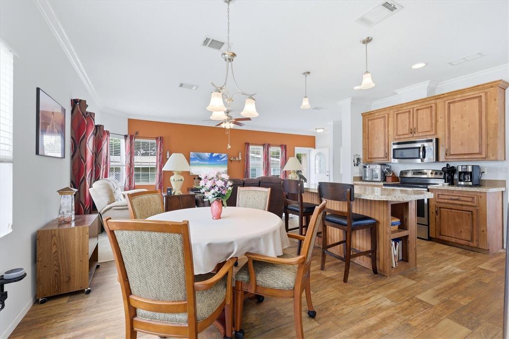 1 Meadow Circle Ellenton, FL 34222 - Photo 11 of 43 a view of a dining room with furniture a chandelier and wooden floor