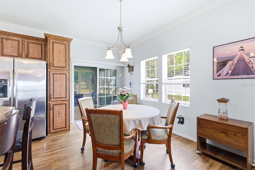 1 Meadow Circle Ellenton, FL 34222 - Photo 13 of 43 a dining room with furniture a chandelier and wooden floor