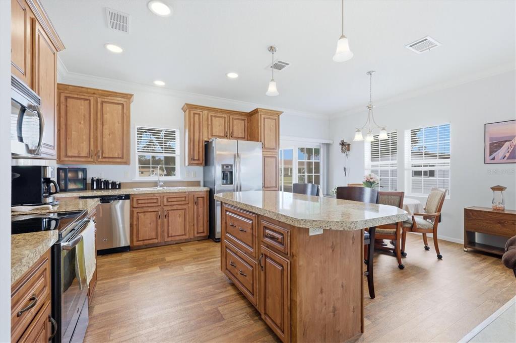 1 Meadow Circle Ellenton, FL 34222 - Photo 14 of 43 a kitchen with kitchen island granite countertop lots of counter top space and stainless steel appliances