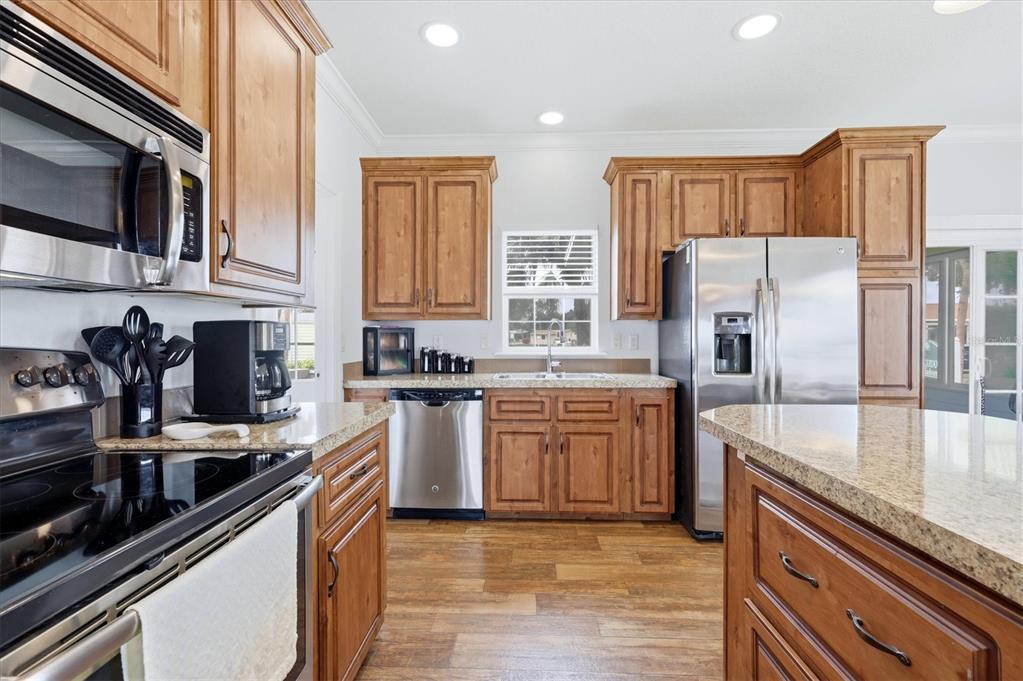 1 Meadow Circle Ellenton, FL 34222 - Photo 15 of 43 a kitchen with stainless steel appliances granite countertop a sink stove and refrigerator