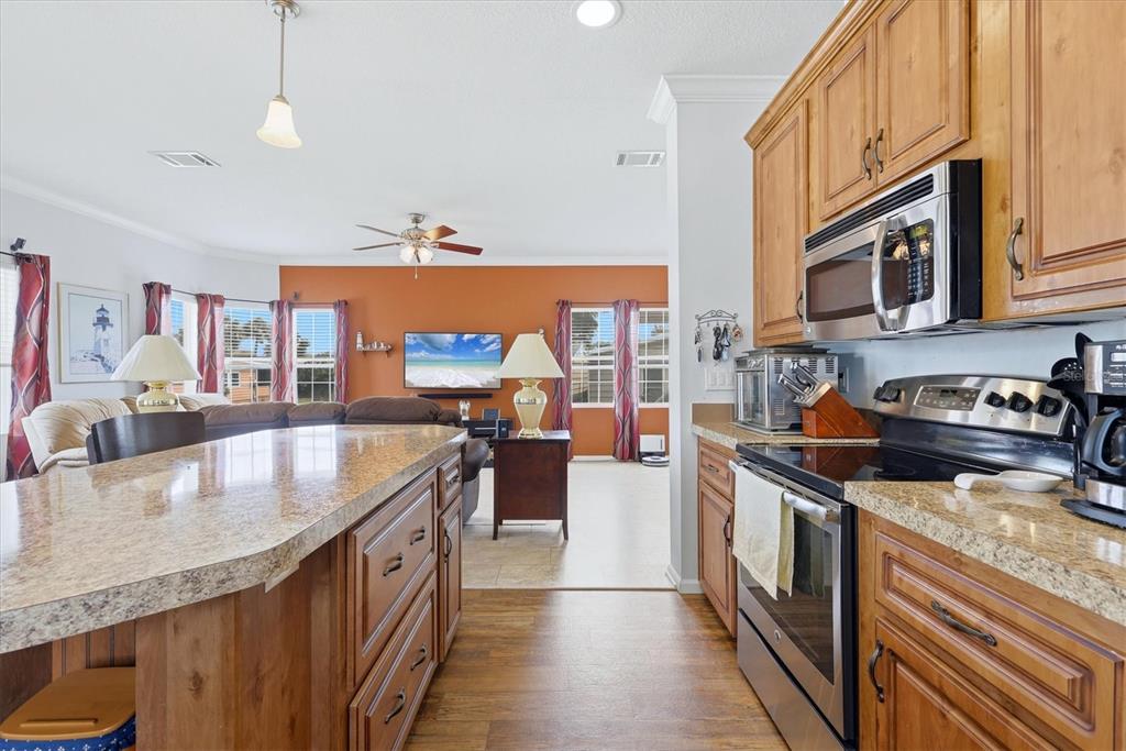 1 Meadow Circle Ellenton, FL 34222 - Photo 18 of 43 a kitchen with stainless steel appliances granite countertop a sink stove and refrigerator