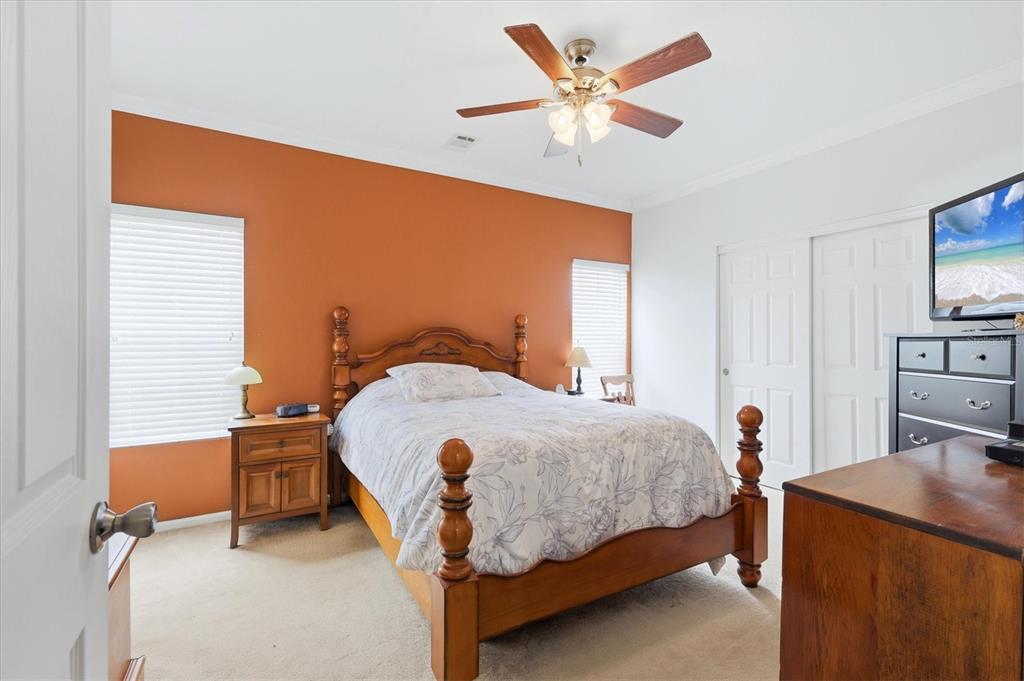 1 Meadow Circle Ellenton, FL 34222 - Photo 19 of 43 a bedroom with a bed and a chandelier