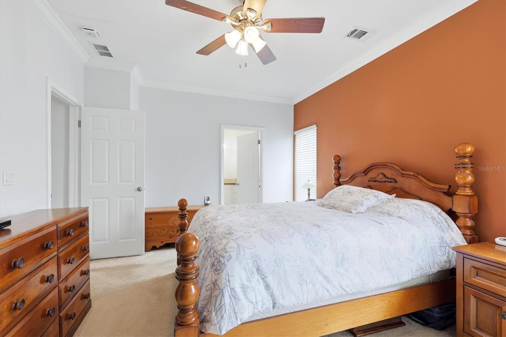 1 Meadow Circle Ellenton, FL 34222 - Photo 20 of 43 a bedroom with a bed and a chandelier