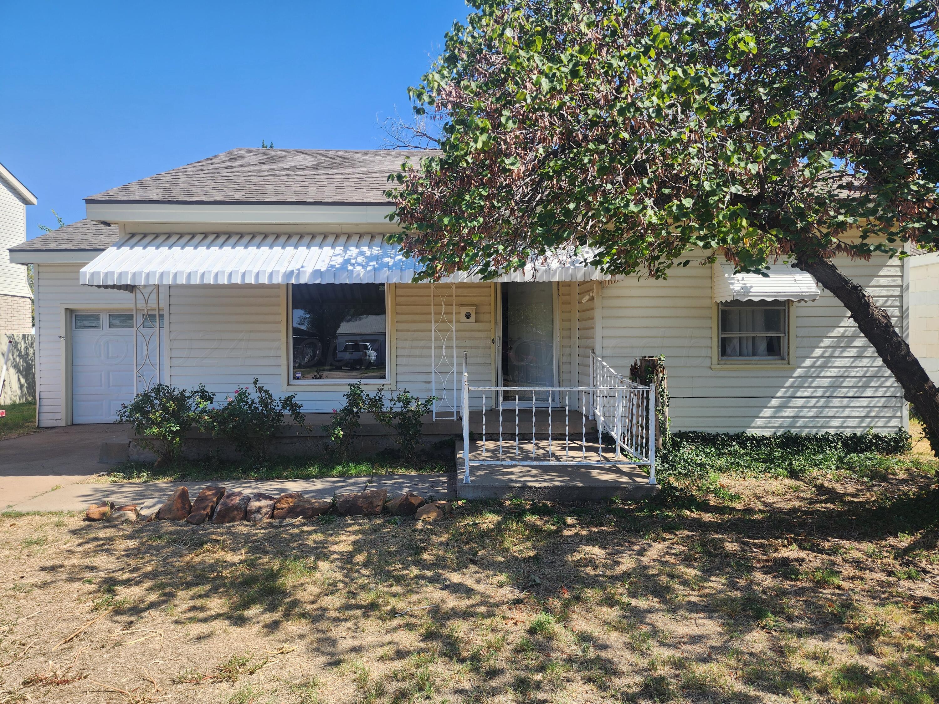 4003 Cline Road Amarillo, TX 79110 - Photo 1 of 17 a front view of a house with garden
