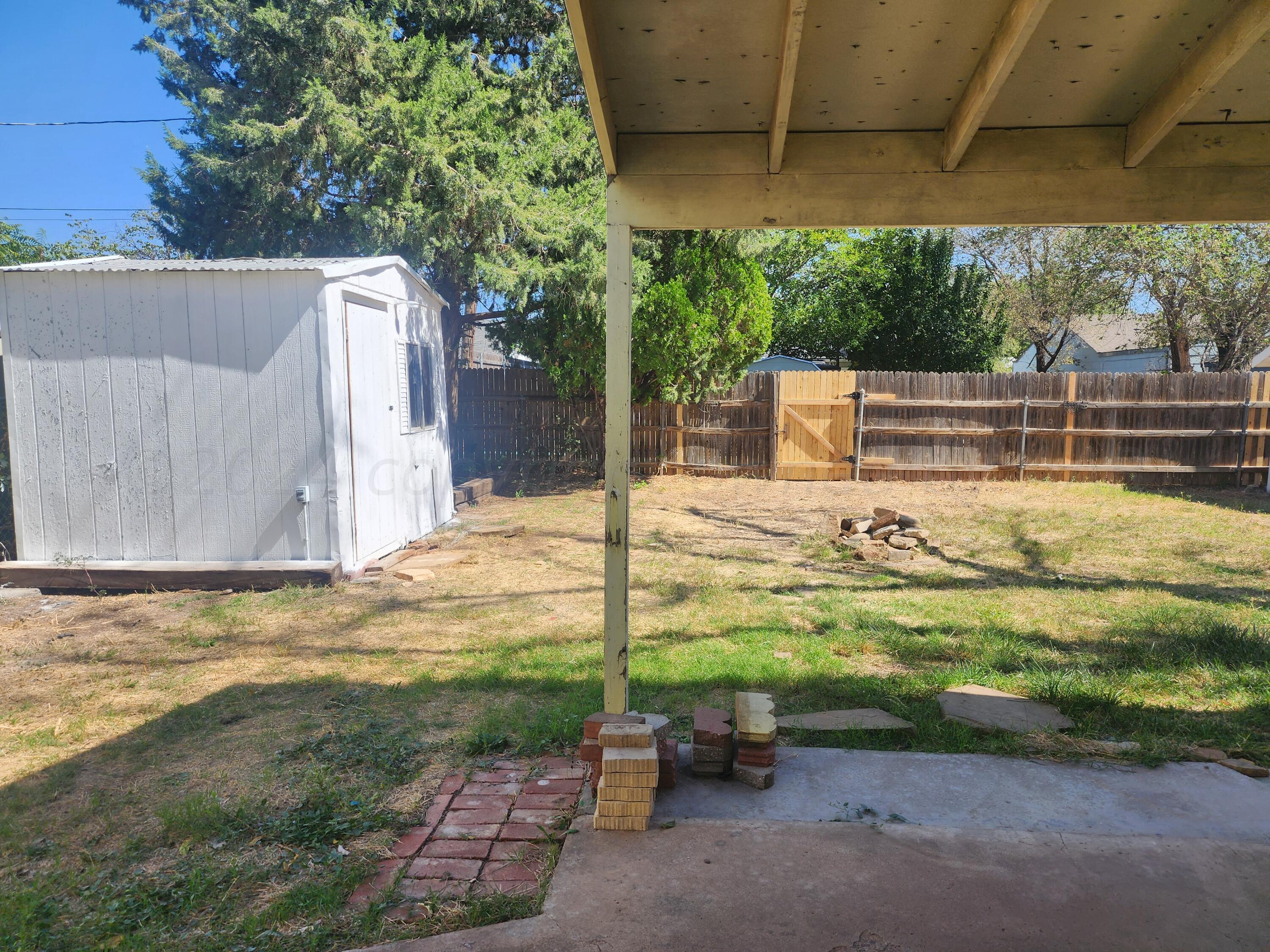 4003 Cline Road Amarillo, TX 79110 - Photo 14 of 17 a backyard of a house with a yard and outdoor seating