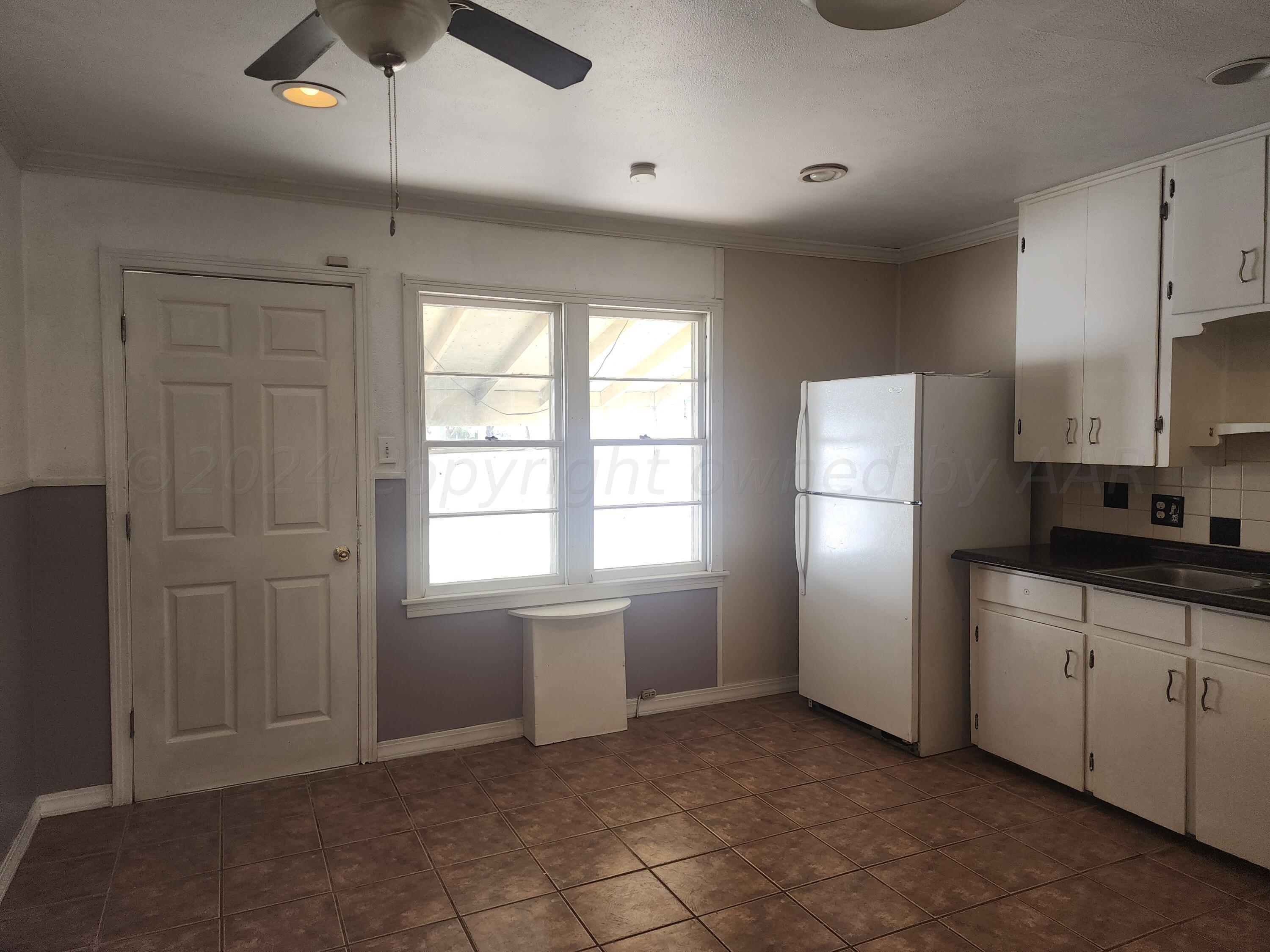 4003 Cline Road Amarillo, TX 79110 - Photo 4 of 17 a kitchen with cabinets and stainless steel appliances