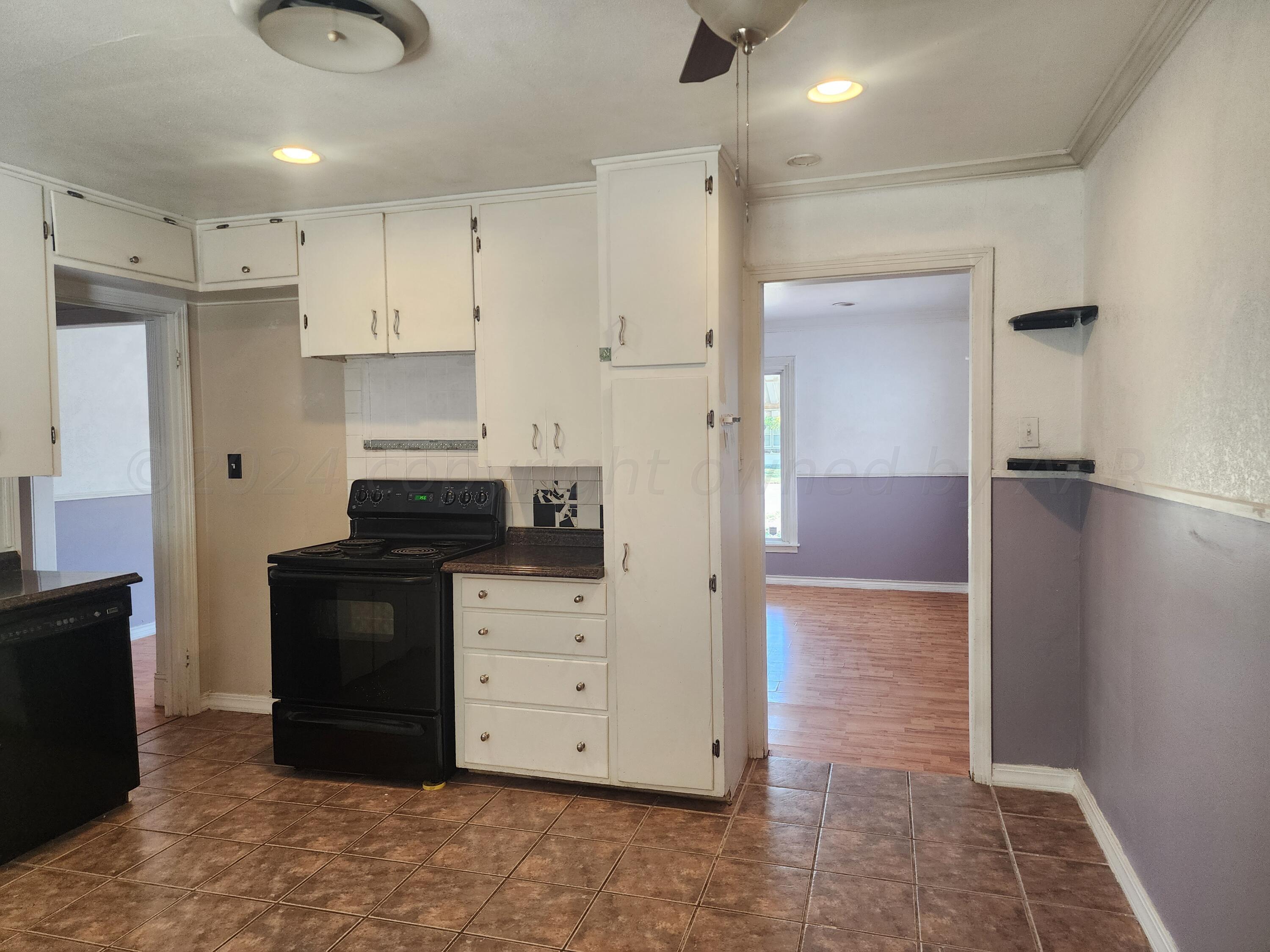 4003 Cline Road Amarillo, TX 79110 - Photo 6 of 17 a kitchen with stainless steel appliances granite countertop a refrigerator and a stove