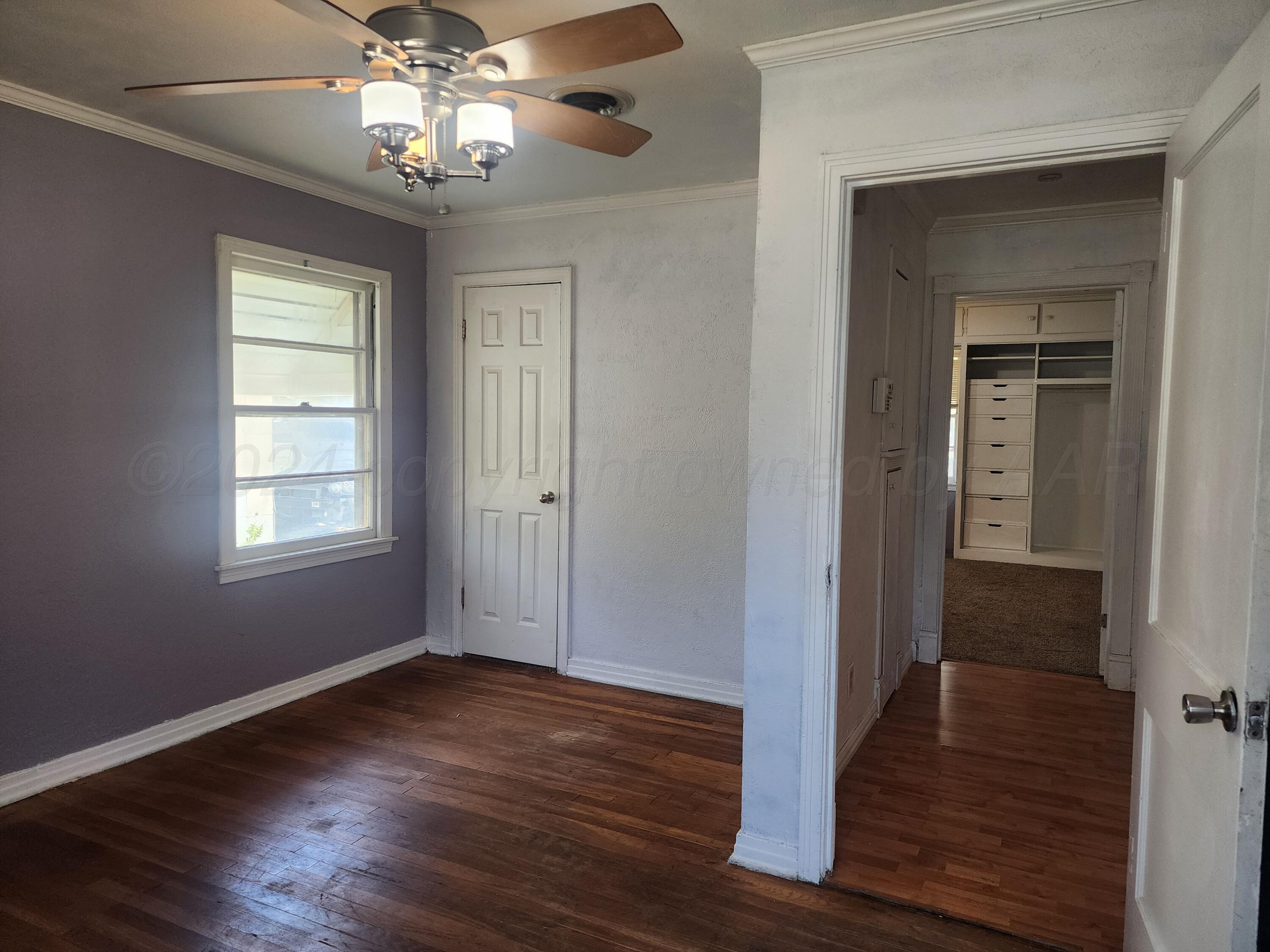 4003 Cline Road Amarillo, TX 79110 - Photo 7 of 17 a view of empty room with wooden floor