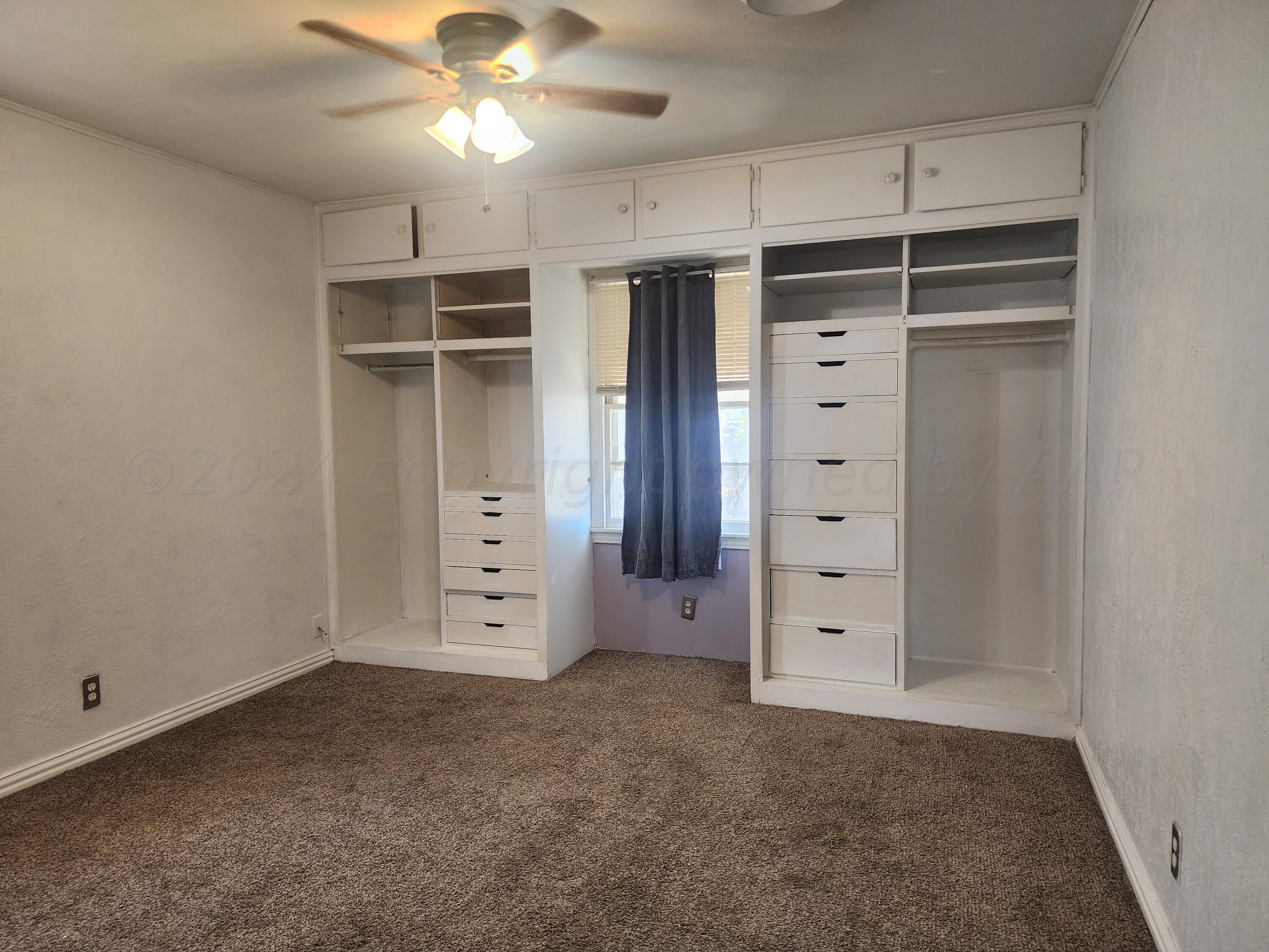 4003 Cline Road Amarillo, TX 79110 - Photo 9 of 17 an empty room with closet and a ceiling fan