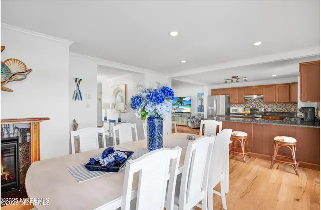 a dining room with furniture a fireplace and chandelier