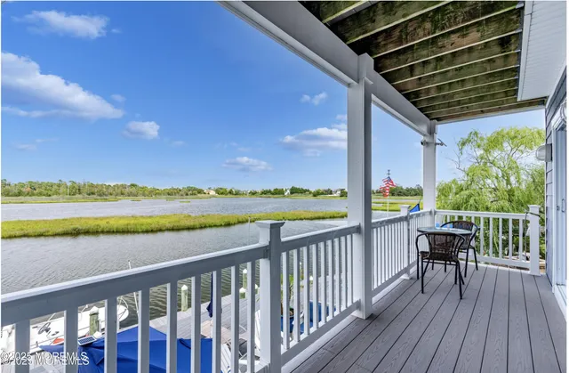 a view of a balcony with wooden floor and fence